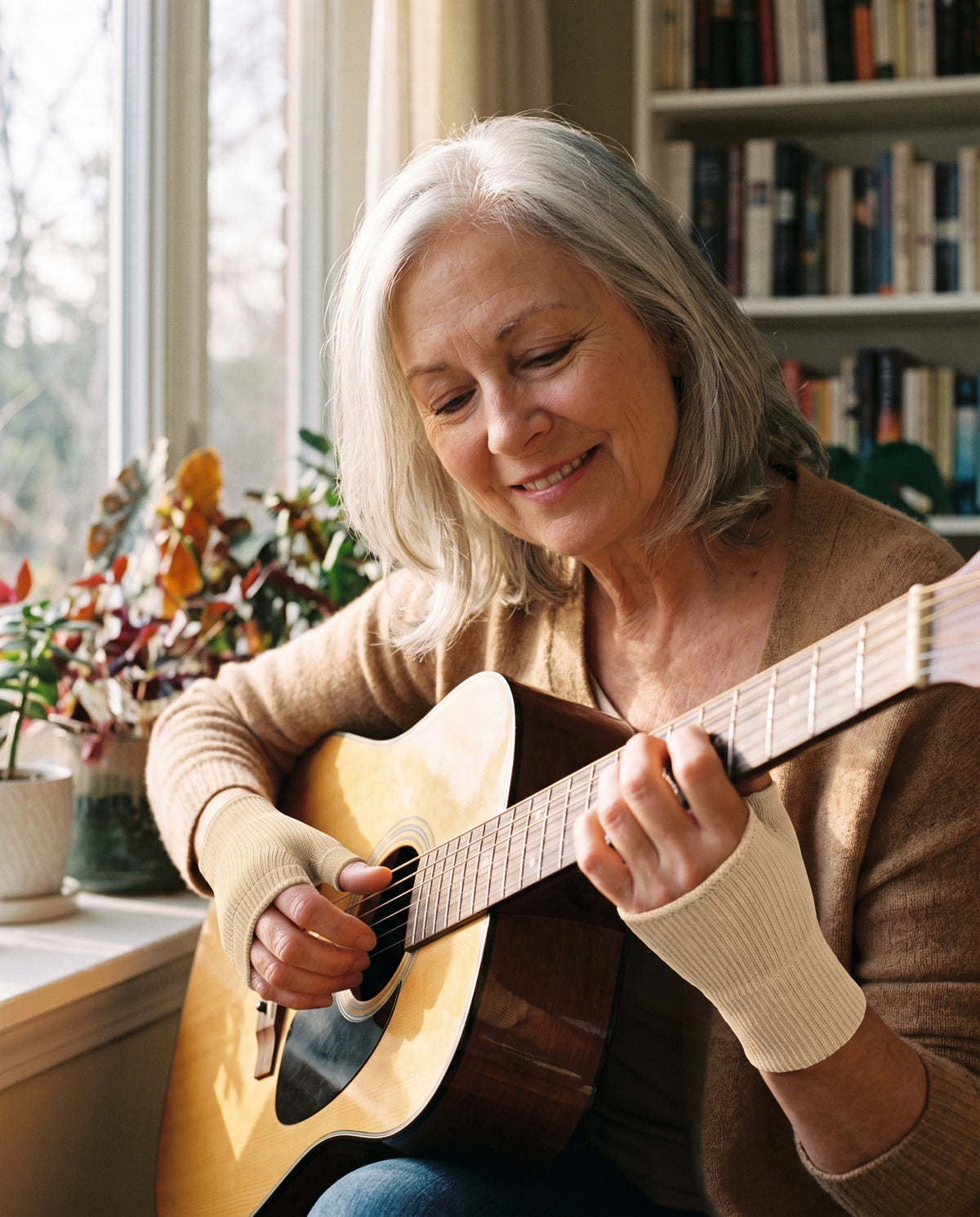 Guitar player smiling while playing, wearing the Halovo Hands thumb and wrist support sleeve