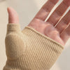 Close video of the sleeve worn on a hand, the cushioned pad sitting over the base of the thumb and the single ribbed edge across the palm, with all four fingers and the thumb left completely bare